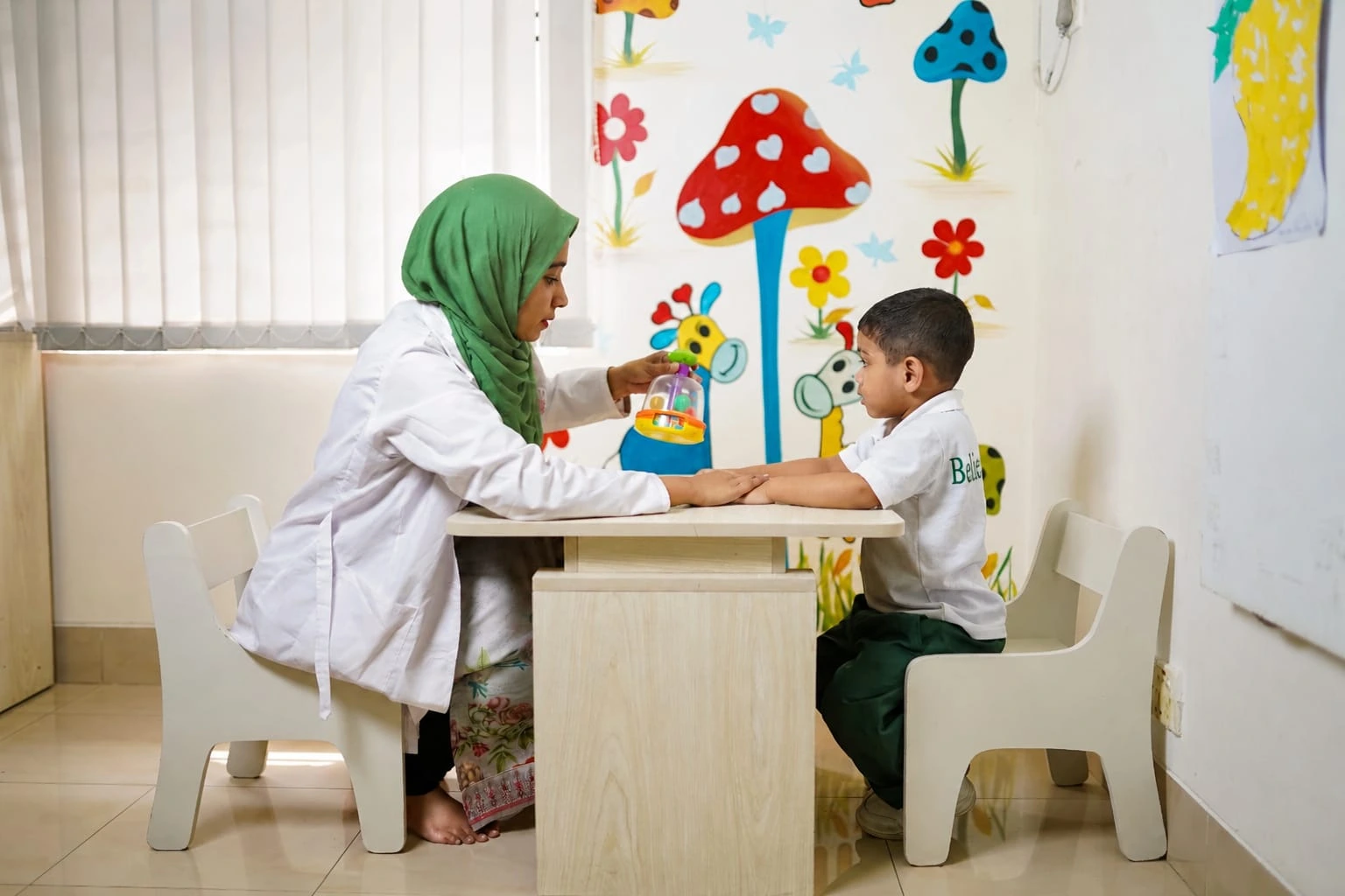 KiddieRocks certified therapists working with a special needs child in Dhaka Bangladesh